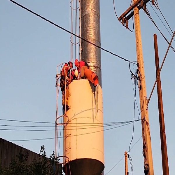 Equipes do Corpo de Bombeiros trabalhando para conseguir retirar o corpo da caixa d'água.